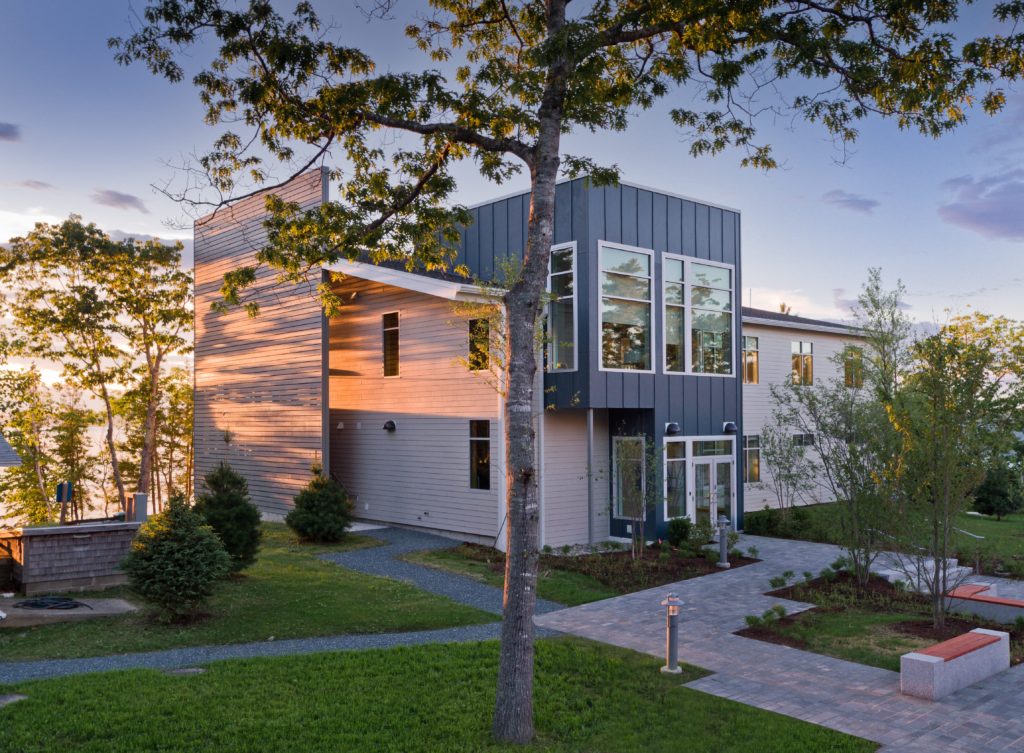 The exterior design of the MDI Biological Laboratory bathed in the light of a sunset.