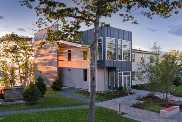 The exterior design of the MDI Biological Laboratory bathed in the light of a sunset.